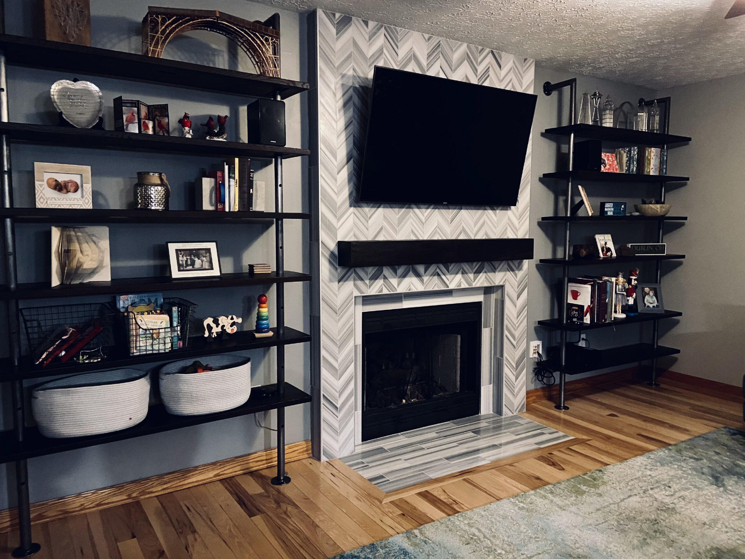 Living room with a fireplace and a flat screen tv mounted on the wall