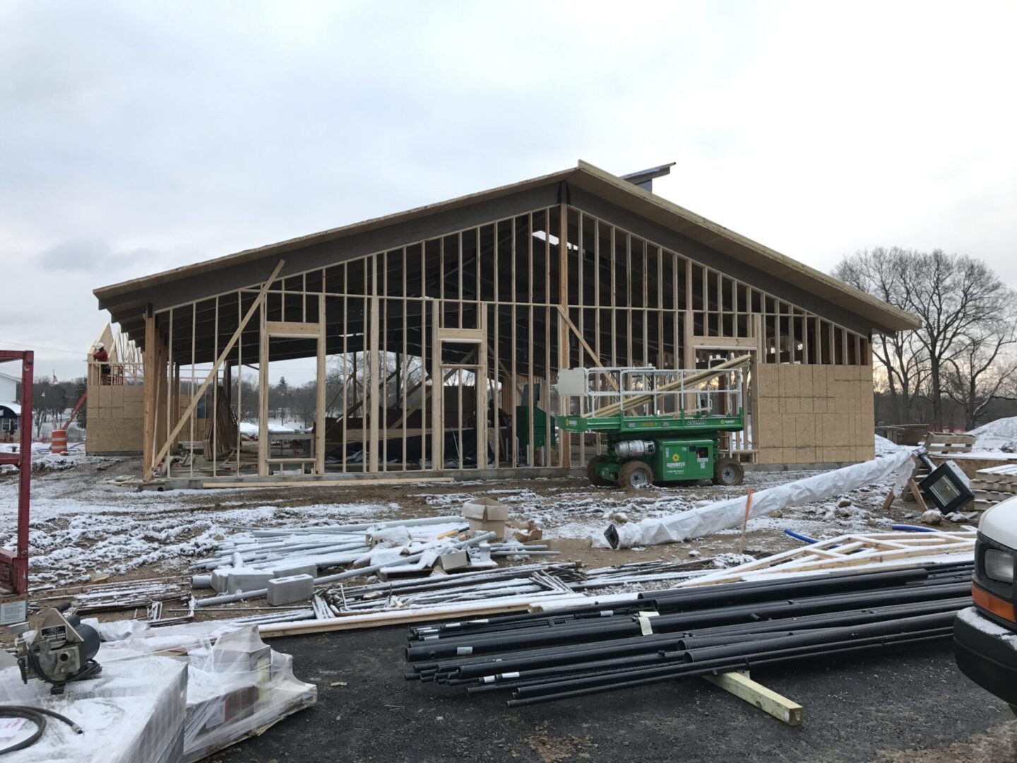 Large building under construction with a truck parked in front of it