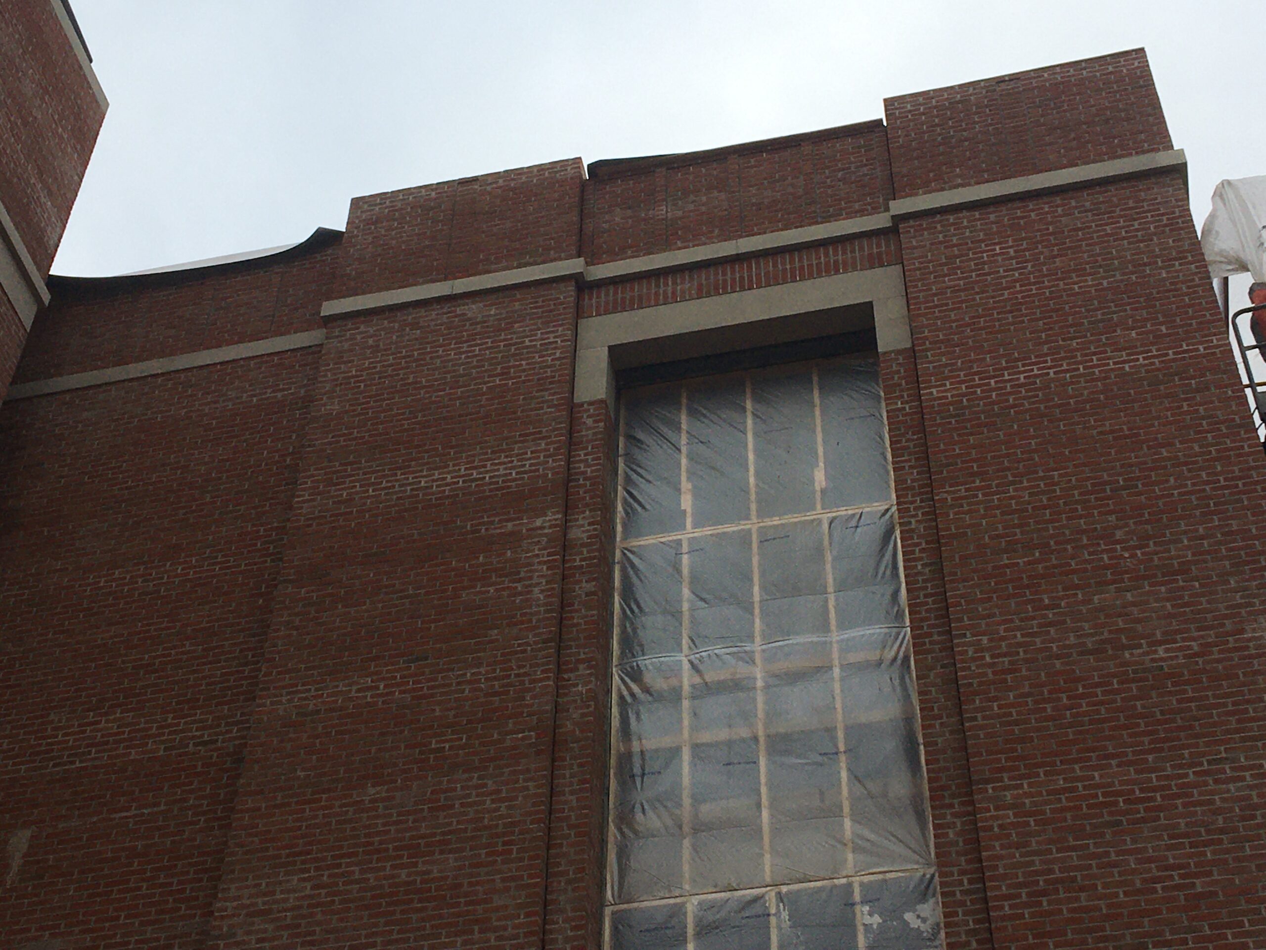 Brick building with a large window on the side of it