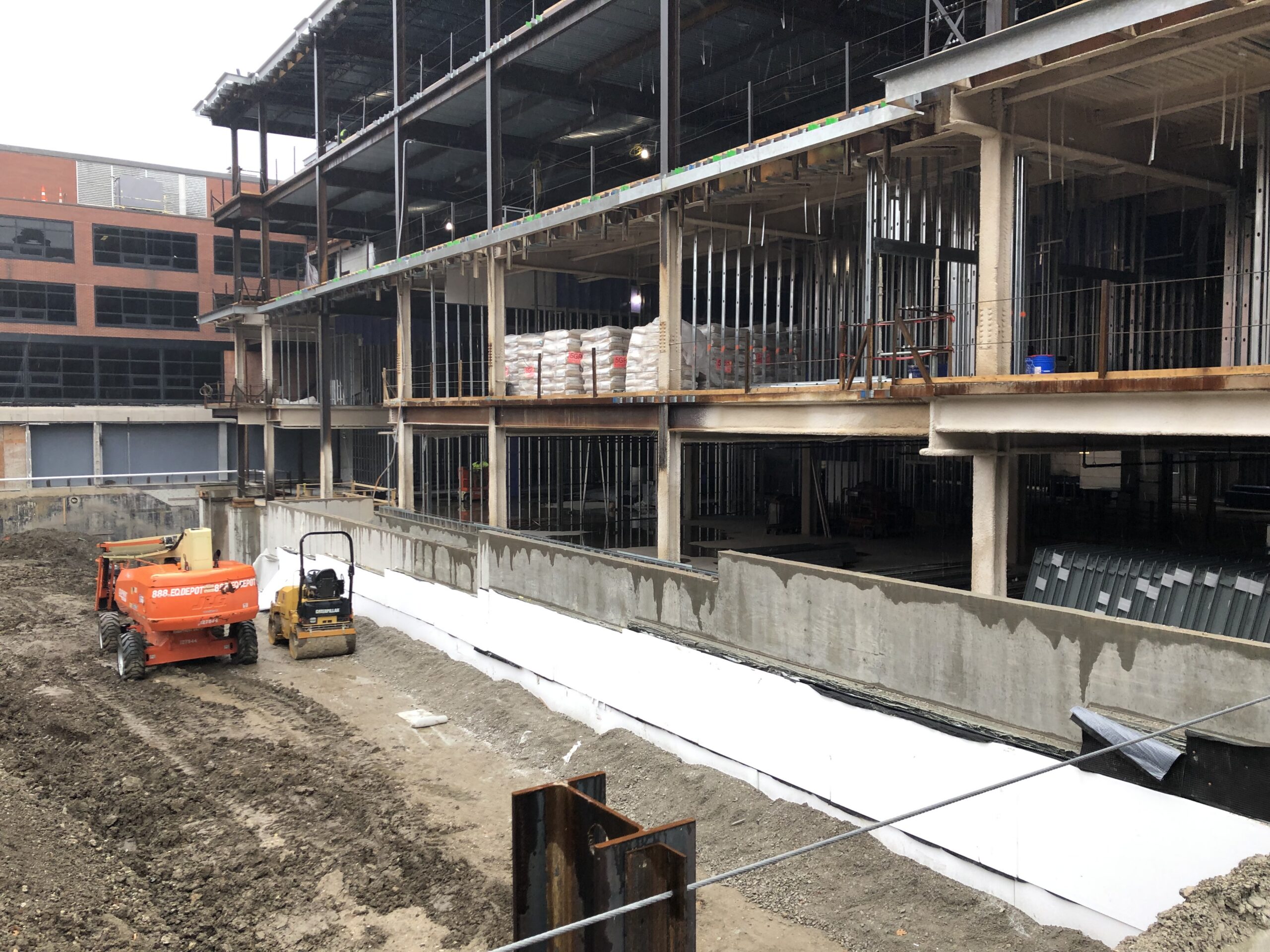 Construction site with a large building under construction in the background