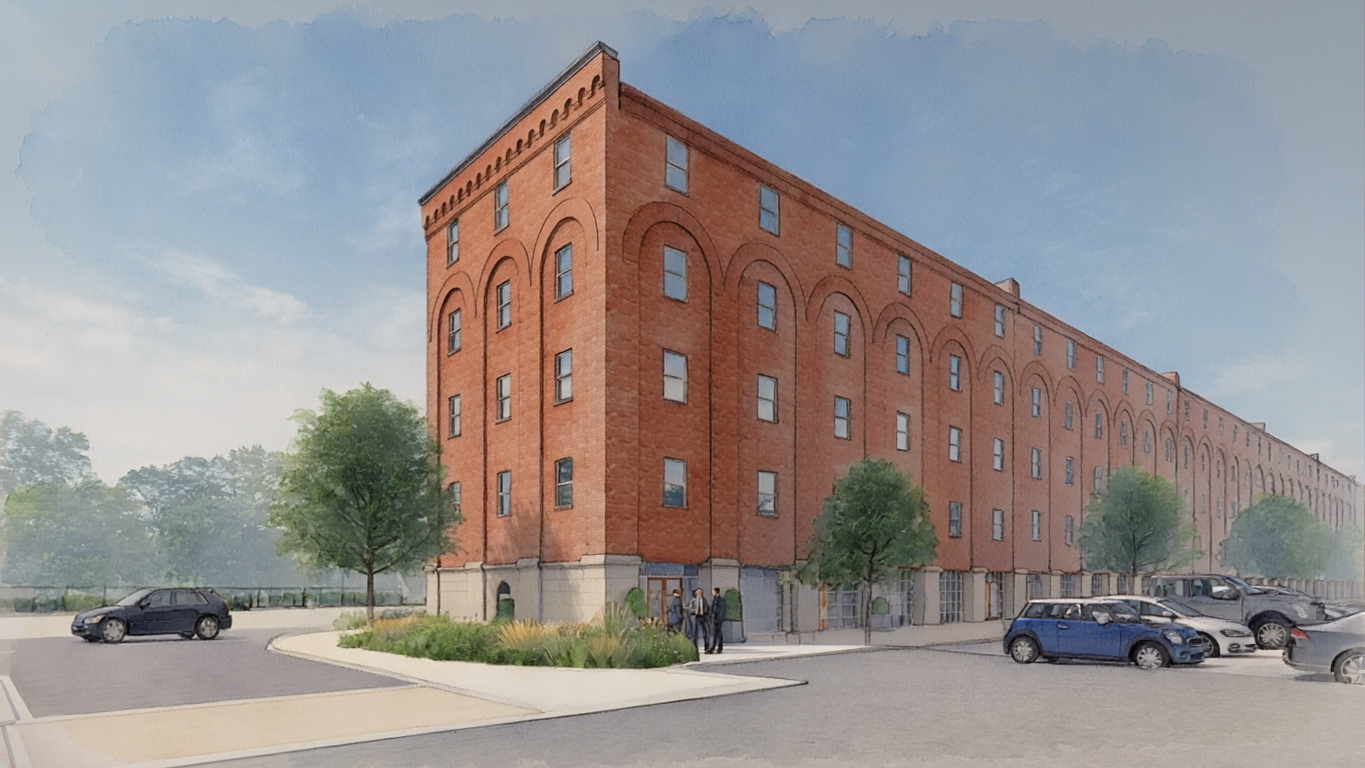 Artist's rendering of a proposed brick building with a parking lot in front of it, surrounded by trees, plants