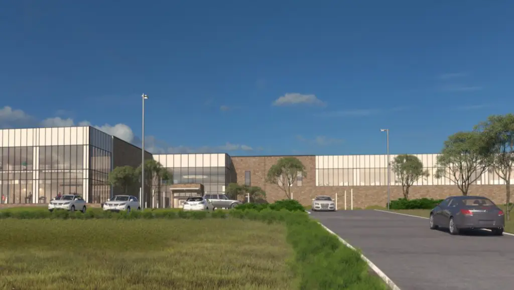 Artist's rendering of the new building at the corner of a parking lot, with vehicles on the road, grass, plants
